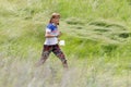 GRUNIVKA, SUMY REGION, UKRAINE - JUNE 20, 2021: Sportswoman running through the field on SKIF Cup XIV sports