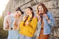 Grup of three girls with funny lips, glasses, stars, paper hearts on stick at the sunset having fun. Going crazy, smile at summer