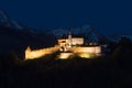 Gruyere, VD / Switzerland - 31 May 2019: view the historic castle at Gruyere with snowcapped mountain landscape at twilight