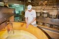 Worker makes cheese at a cheese factory in Gruyeres, Switzerland.