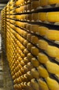 Gruyeres, Switzerland - July 27, 2019: Cheese wheels maturing in the cellar storage of the famous Swiss cheese factory Royalty Free Stock Photo