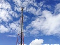 GSM repeater tower in front of blue cloudy sky Royalty Free Stock Photo