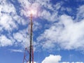 GSM repeater tower in front of blue cloudy sky Royalty Free Stock Photo