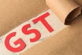 GST word and torn paper. Taxes on the background of craft paper Royalty Free Stock Photo