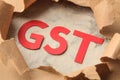 GST word and torn paper. Taxes on the background of craft paper Royalty Free Stock Photo