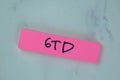 GTD - Getting Things Done write on sticky notes isolated on Wooden Table