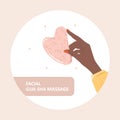 Gua sha scraper for facial massage. African female hand holding natural pink quartz stone. Trendy beauty treatment. Skin