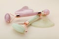 Gua sha tools and facial rollers on beige background