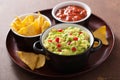 Guacamole with avocado, lime, chili and tortilla chips Royalty Free Stock Photo
