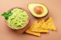 Guacamole bowl avocado and chips isolated on table. Flat lay