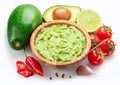 Guacamole bowl and guacamole ingredients isolated on white background. Flat lay Royalty Free Stock Photo