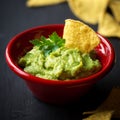 Guacamole dip with nachos on black Royalty Free Stock Photo