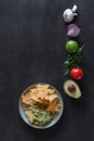 Plate of guacamole with tortilla chips and ingredients Royalty Free Stock Photo