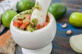 Guacamole - latin american sauce and ingredients avocado, tomatoes, onion, lemon, garlic, lime on blue wooden background. Royalty Free Stock Photo