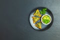 Guacamole and nachos with ingredients on the background of a black stone board Royalty Free Stock Photo