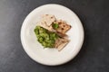 Guacamole with pita chips on white plate, close-up. Mexican guacamole Royalty Free Stock Photo