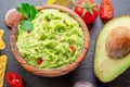 Guacamole sauce and guacamole ingredients, popular Mexican food, on slate serving board. Top view
