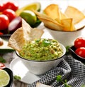 Guacamole is a traditional Mexican dip made of avocado, onion, tomatoes, coriander, chilli peppers, lime and salt with the additio Royalty Free Stock Photo