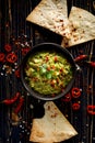 Guacamole is a traditional Mexican dip made of avocado, onion, tomatoes, coriander, chilli peppers, lime and salt with the additio Royalty Free Stock Photo