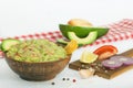 Guacamole with vegetables and snacks in a wooden bowl, vegan snack, vegetarian concept dinner.