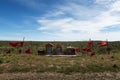 A Guachito Gil shrine with red flags along a road at the Valdes Peninsula in Argentina Royalty Free Stock Photo