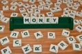 Money word made up of letter tiles surrounded by letters. Woden Table