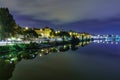 Guadalquivir river of Seville, night scene with lights in the city and reflections in the calm water, panoramic cityscape Royalty Free Stock Photo