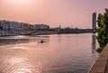 Guadalquivir river with silhouette of a canoeist, and architecture of city at evening, SPAIN Royalty Free Stock Photo