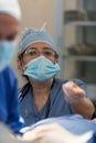 Nurse assists during surgery