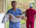 Guadalupe, Ecuador - May 27, 2014: Surgeon takes child to recovery room