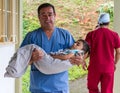 Guadalupe, Ecuador / May 27, 2014: Surgeon takes child to recovery room