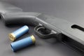 A 12 guage Shotgun with Blue shotgun shells Royalty Free Stock Photo