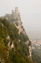The Guaita fortress cliff in the morning fog. City of San Marino. San Marino Royalty Free Stock Photo