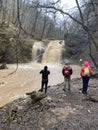 Guamka, Russia april 17, 2021: Beautiful landscape of powerful muddy waterfall in mountainous terrain. Dirty mountain