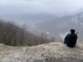 Guamka, Russia april 17, 2021: Tourists on huge cliff with spectacular view of nature. Group of people on high rock in