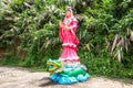 Guan Yin statue standing on dragon with tree background Royalty Free Stock Photo