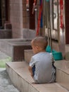 Little Chinese boy playing on a narrow alley of Xiaozhou Village, China
