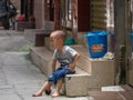 Little Chinese boy playing on a narrow alley of Xiaozhou Village, China