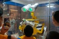 people watching a robot playing a Rubik`s Cube in a science museum
