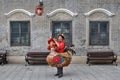 GUANGZHOU, CHINA Ã¢â¬â CIRCA JUNE 2020: Street vendor in Guangzhou dressed up as a colorful rooster.