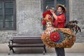 GUANGZHOU, CHINA Ã¢â¬â CIRCA JUNE 2020: Street vendor in Guangzhou dressed up as a colorful rooster.