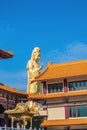 Guanyin goddress with temple rooftop and beautiful sky at foguangshan thaihua temple thailand