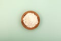 Guar gum powder or guaran in wooden plate, top view. Food additive E412. Guar Gum used in cosmetics and food industry Royalty Free Stock Photo