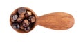 Guarana seed in wooden spoon, isolated on white background. Dietary supplement guarana, caffeine cource for energy