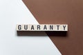 Guaranty - word concept on cubes