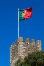 Guard castle tower Castelo de S. Jorge with the Portuguese flag, Lisbon Royalty Free Stock Photo