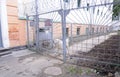 guard dog barking in the prison yard of Lukyanovskaya detention facility SIZO , bars and barbed wires