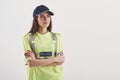 On guard of order. Pretty woman in green police uniform stands against white background in the studio Royalty Free Stock Photo