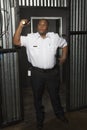 Guard With Torch At Corrugated Doorway Royalty Free Stock Photo