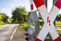 Guarded railroad crossing in the countryside with open barriers and cross of Saint Andrew. Royalty Free Stock Photo